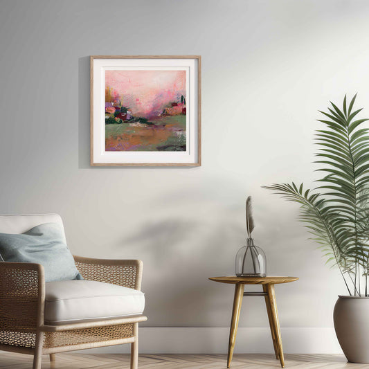 Living room with a framed painting, chair, side table, and plant.
