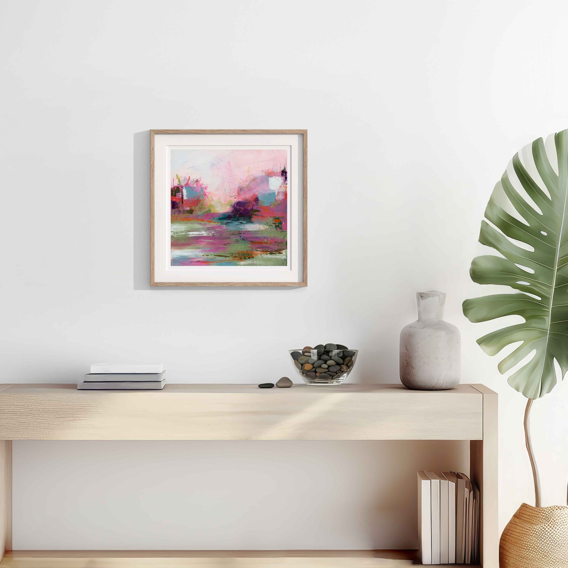 Modern interior with a console table, abstract painting, and plant.