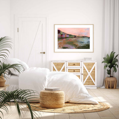 Meet Me Before The Sunsets paper print in an oak frame and white mount. Set in a bedroom with white walls and wicker furnishings