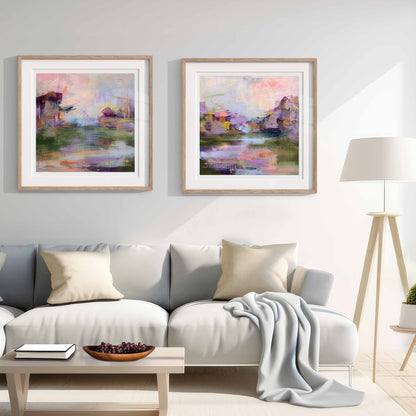 Living room with a gray sofa, coffee table, and two framed paintings on the wall.