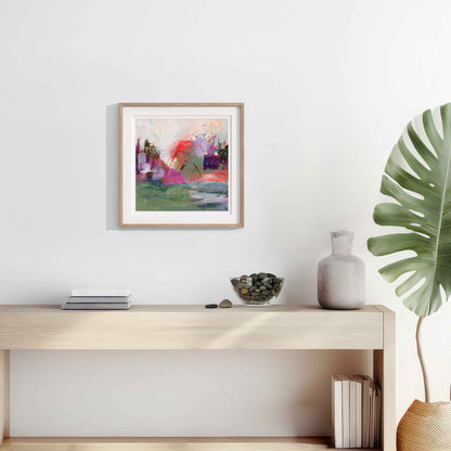 Modern interior with Where The Tide Lifts Abstract art print framed in a wooden frame above a wooden console table, and decorative items.