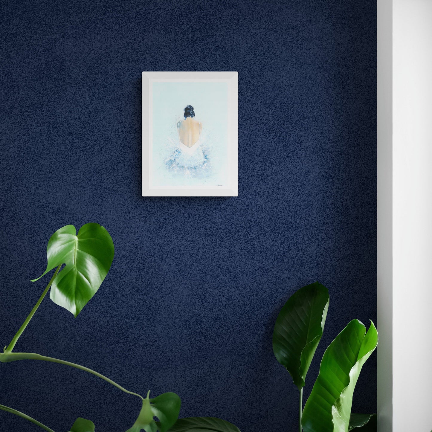 A print of an acrylic painting of a woman sat on the floor wearing a tutu. It is hung on a dark blue wall with a house plant just below