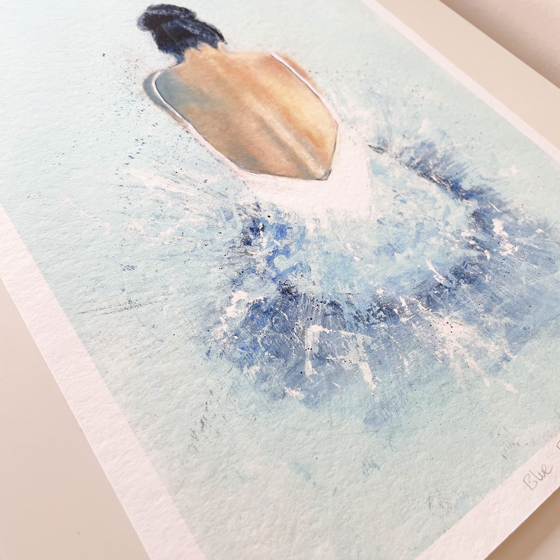 Print of an acrylic painting of a ballerina painted in blue. The photo os taken from an angle